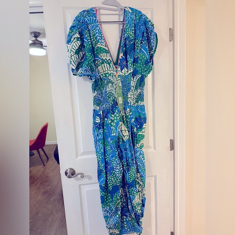 Farm Rio - vibrant tropical print jumpsuit in blues, greens, and white.